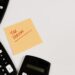 tax season written on post-it surrounded by calculators